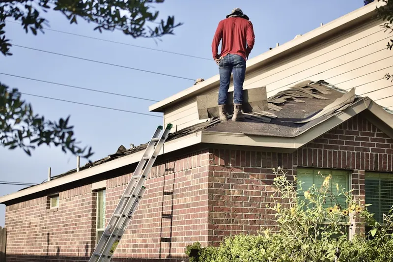 Professional roofer working on a residential roof in Fontainebleau Park West